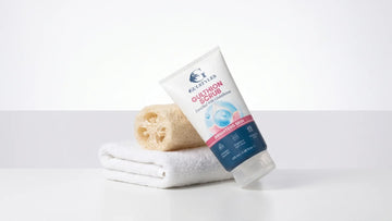 Gulthion body scrub beside a towel and a loofah