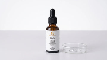 Rizea rice serum beside a small glass dish of water droplets