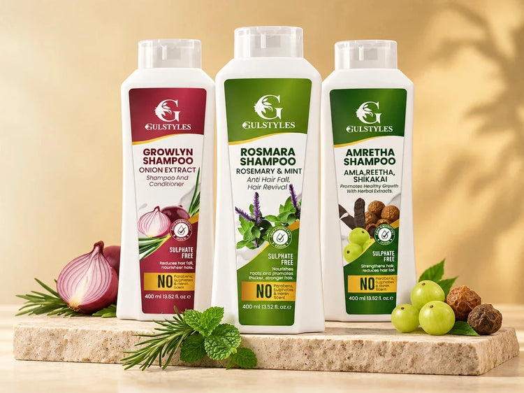 Growlyn, Rosmara and Amretha sulphate-free shampoo bottles on a stone slab with onion, rosemary, mint, amla and reetha